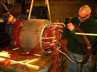 Rewinding coils on an AC Motor core that has been removed from the stator, prior to the varnish treatment