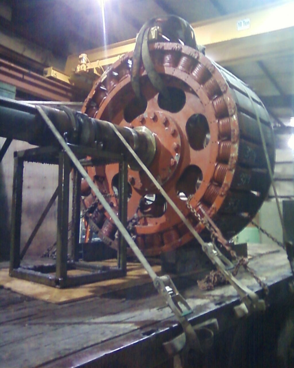 5000 Hp Synchronous rotor secured with cables to a platform, ready for repair