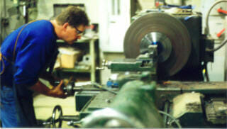 machinist building a custom part by machining a coupling