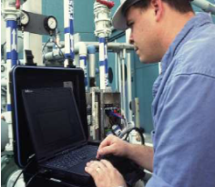 Technician performing MCE analysis using laptop software and MCE testing equipment